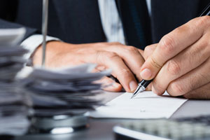 Agent writing at desk